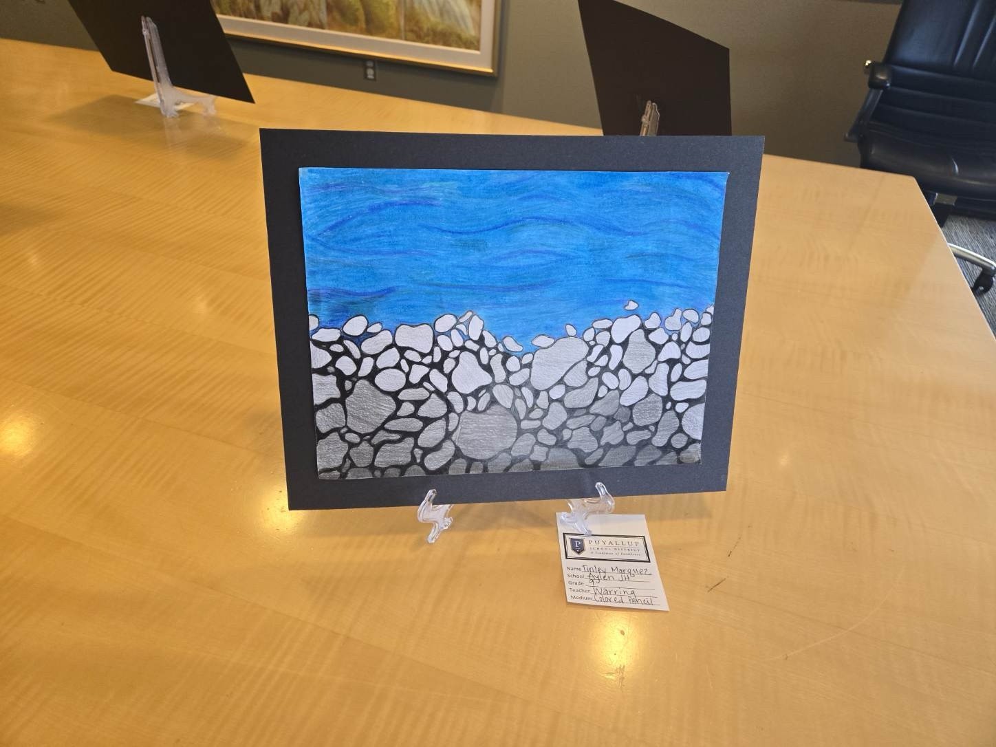 Student-created art of a rock wall beneath water.