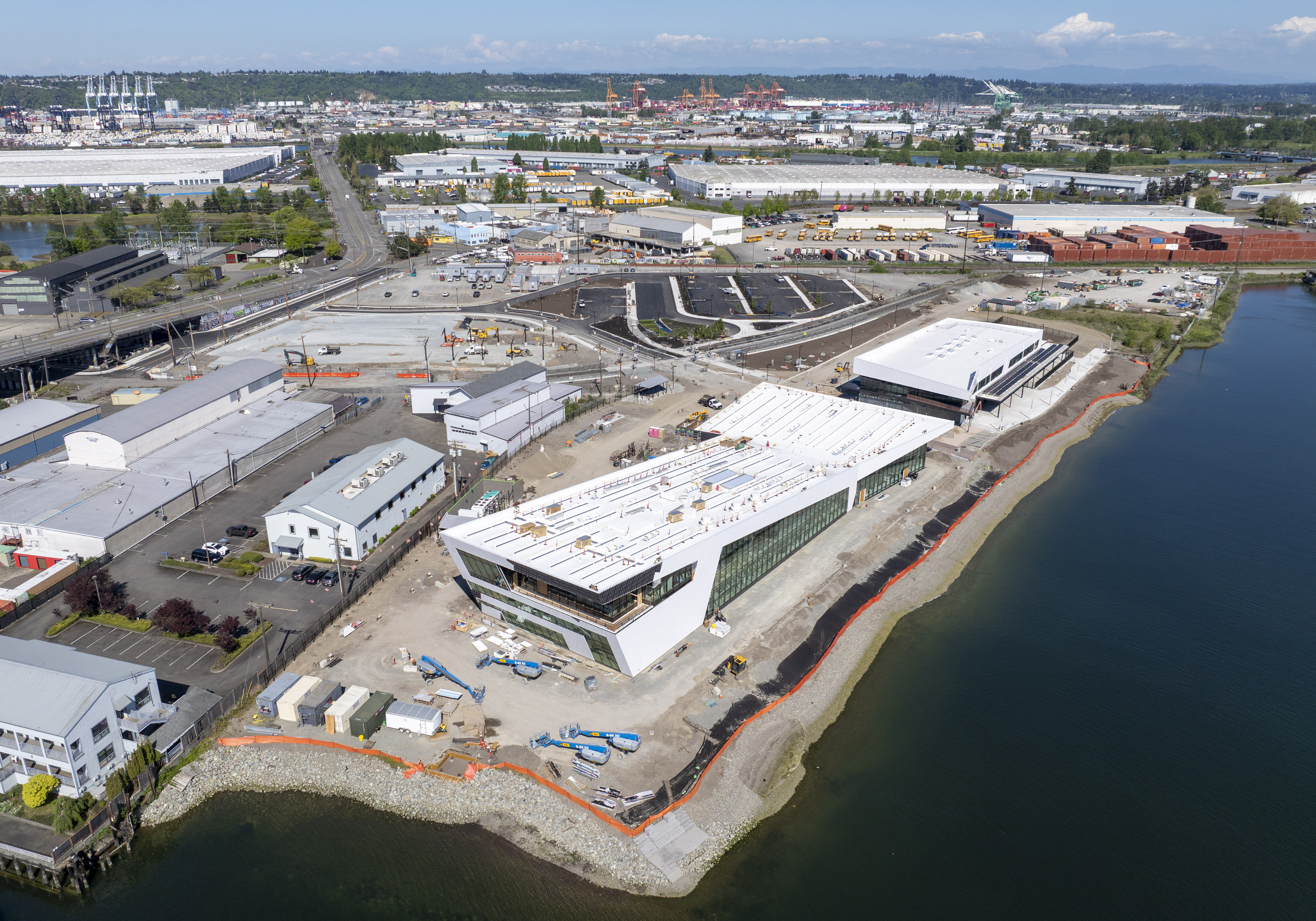 Aerial shot of the Port Maritime Center construction site along the Foss Waterway on a sunny day.