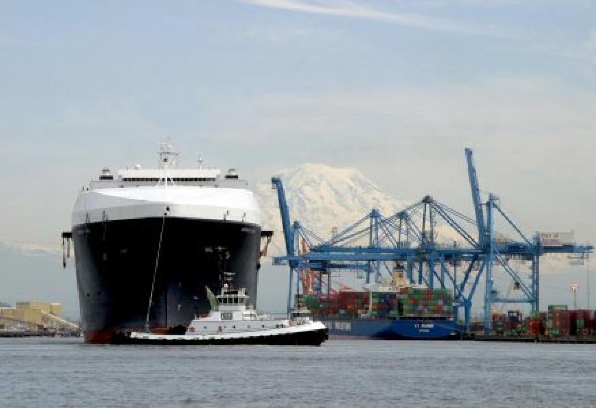A Tote vessel is moved to dock with the help of a Foss tug. 